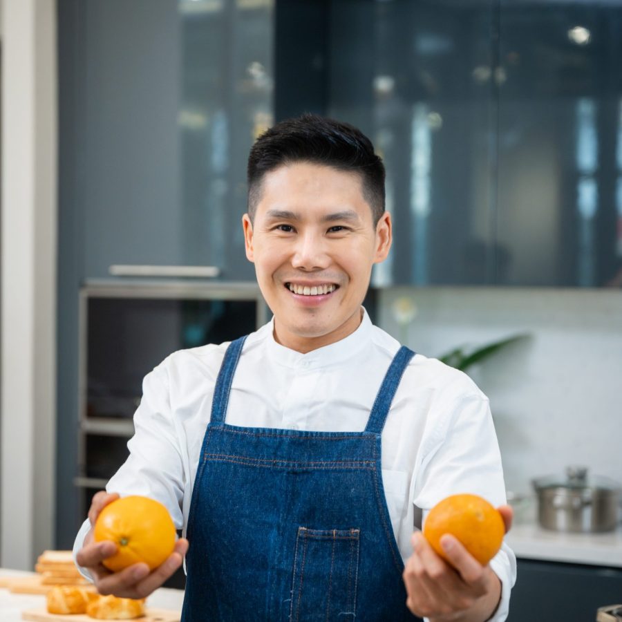 People are showing vegetables and fruits in the kitchen for healthy cooking.